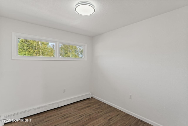 906 Lancaster Dr, Anchorage, AK 99503 - unfurnished room with a baseboard heating unit, dark wood-style floors, and baseboards