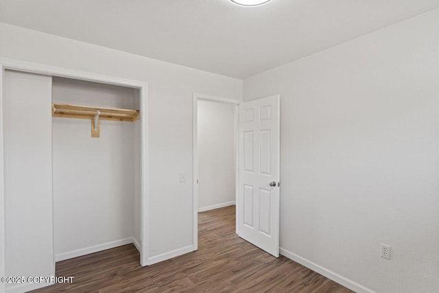906 Lancaster Dr, Anchorage, AK 99503 - unfurnished bedroom with wood finished floors, baseboards, and a closet