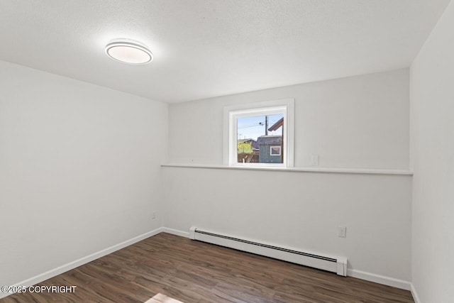 906 Lancaster Dr, Anchorage, AK 99503 - empty room featuring baseboard heating, wood finished floors, and baseboards