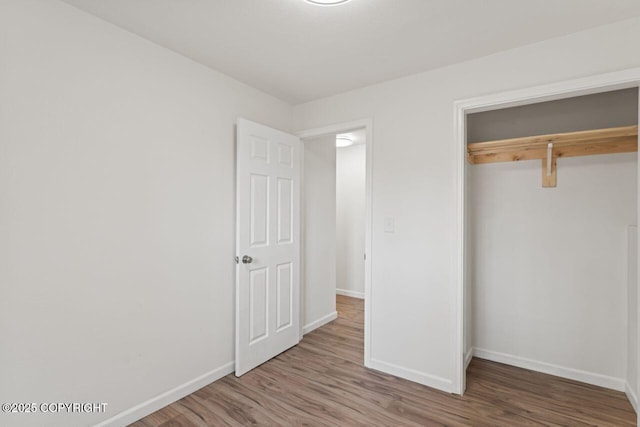 906 Lancaster Dr, Anchorage, AK 99503 - unfurnished bedroom with baseboards and wood finished floors