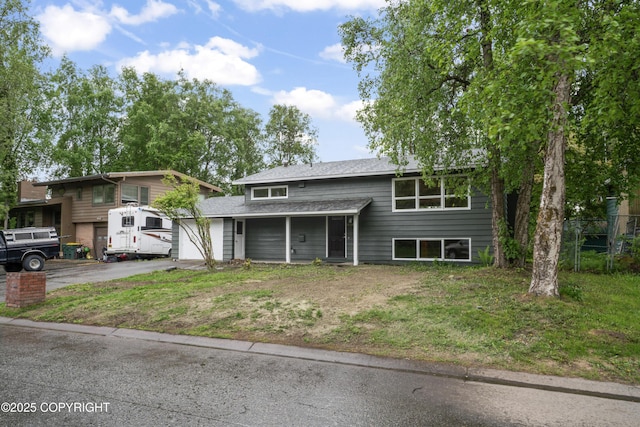 906 Lancaster Dr, Anchorage, AK 99503 - split foyer home with asphalt driveway, an attached garage, and roof with shingles