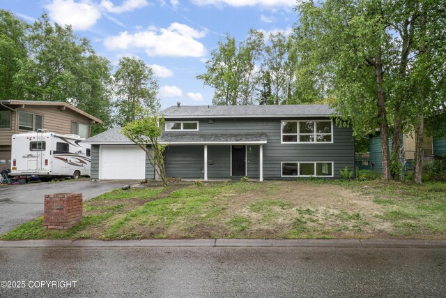 906 Lancaster Dr, Anchorage, AK 99503 - raised ranch with driveway, an attached garage, and roof with shingles