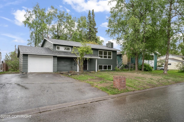 906 Lancaster Dr, Anchorage, AK 99503 - view of front of house featuring a garage, a chimney, asphalt driveway, and roof with shingles