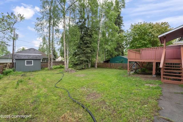 906 Lancaster Dr, Anchorage, AK 99503 - view of yard featuring stairs, a deck, and an outdoor structure