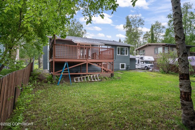 906 Lancaster Dr, Anchorage, AK 99503 - back of property with a wooden deck and roof with shingles