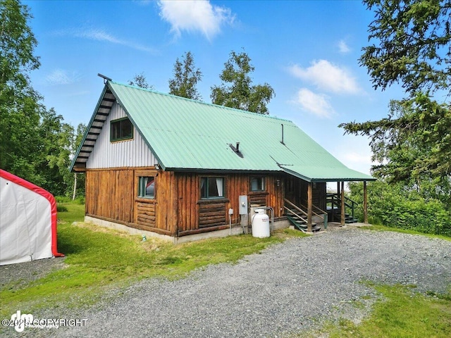 22032 Spring Creek Ln, Chugiak, AK 99567 - view of front of home featuring board and batten siding and a metal roof