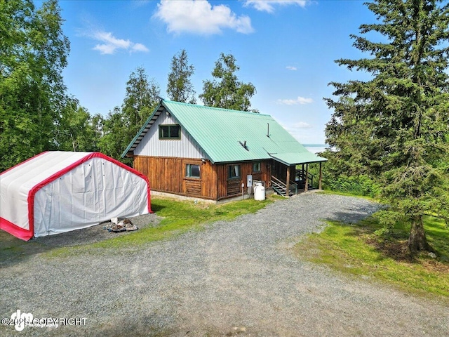 22032 Spring Creek Ln, Chugiak, AK 99567 - view of front of property with a metal roof and gravel driveway