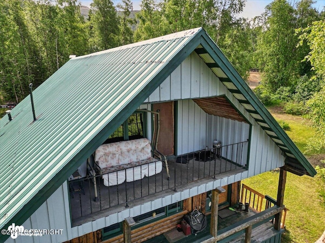 22032 Spring Creek Ln, Chugiak, AK 99567 - view of side of home featuring a metal roof and a wooded view