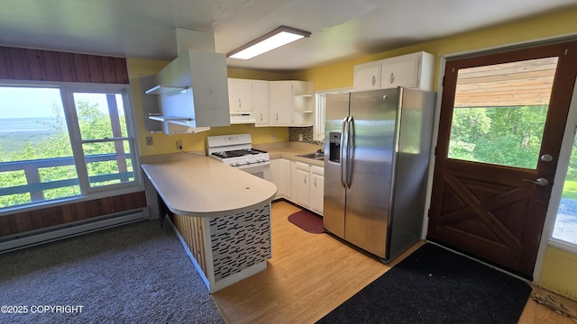 22032 Spring Creek Ln, Chugiak, AK 99567 - kitchen with stainless steel fridge with ice dispenser, open shelves, white gas stove, and plenty of natural light