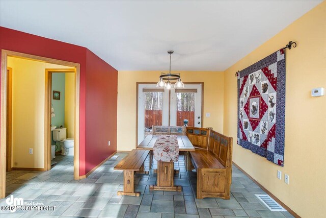 dining area with baseboards, french doors, and visible vents