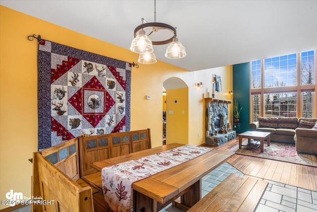 dining room with arched walkways and a notable chandelier