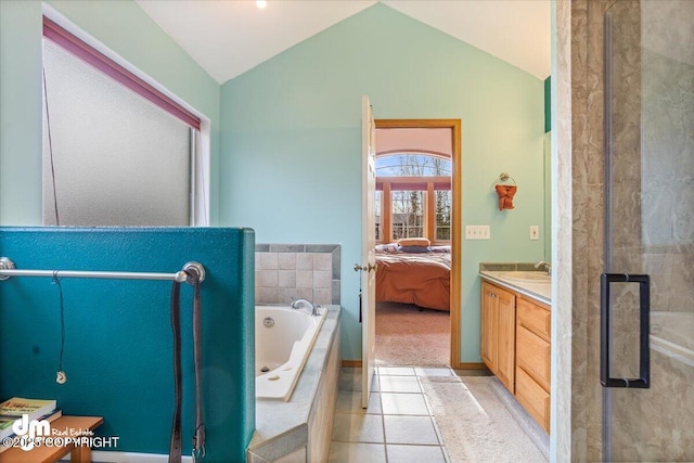 bathroom with ensuite bath, a jetted tub, tile patterned floors, vanity, and vaulted ceiling