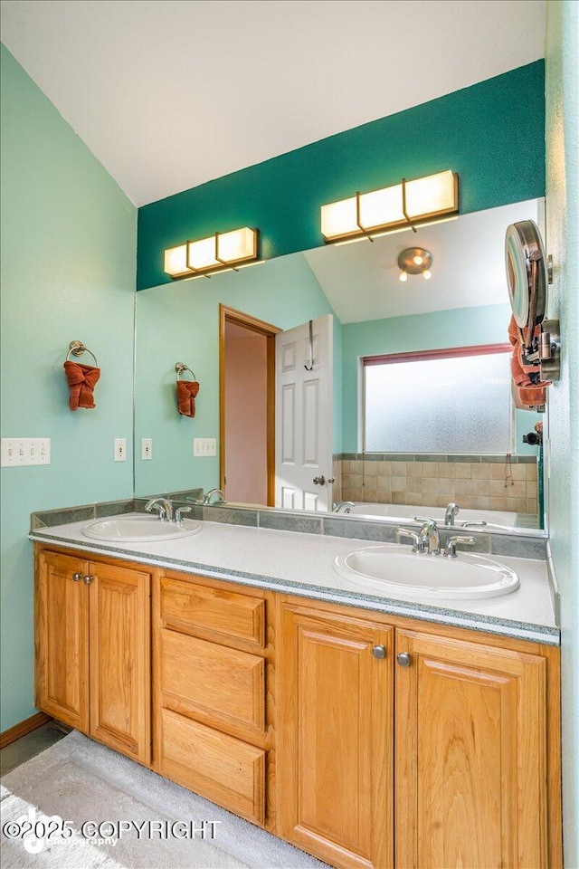 full bath with double vanity, a washtub, and a sink