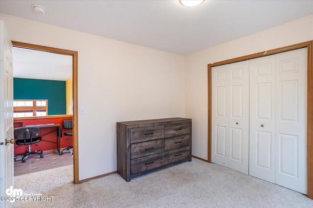 bedroom featuring carpet, a closet, and baseboards