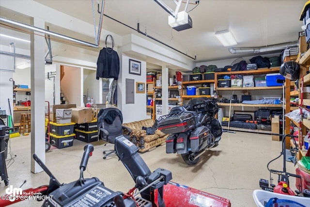 garage featuring electric panel and a garage door opener