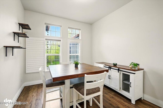 dining room with dark wood-style floors and baseboards