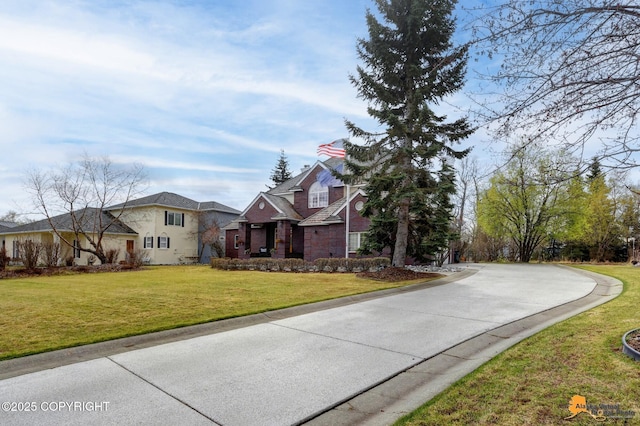 traditional-style house featuring a front lawn and stucco siding