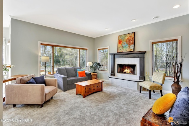 carpeted living room featuring crown molding, a tile fireplace, recessed lighting, and baseboards