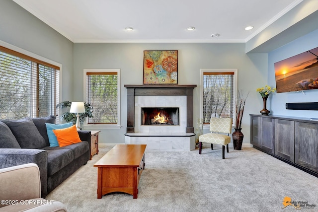 carpeted living area with a fireplace, healthy amount of natural light, crown molding, baseboards, and recessed lighting