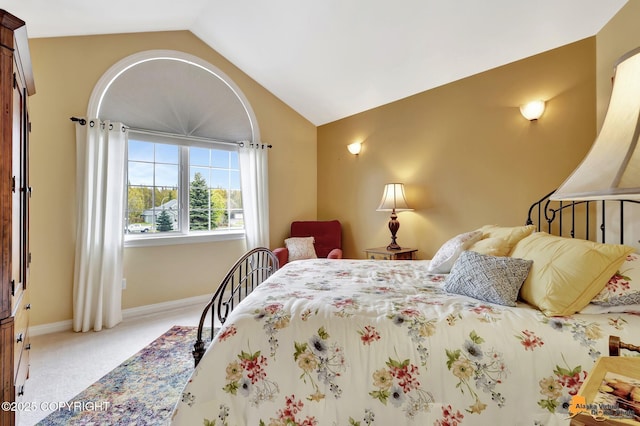 bedroom with vaulted ceiling, carpet, and baseboards