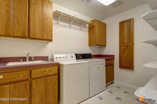 clothes washing area with separate washer and dryer, cabinet space, light tile patterned floors, and baseboards