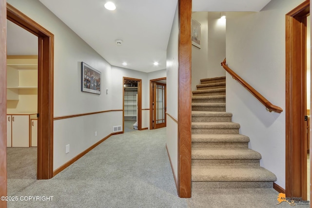 stairs with carpet, recessed lighting, and baseboards
