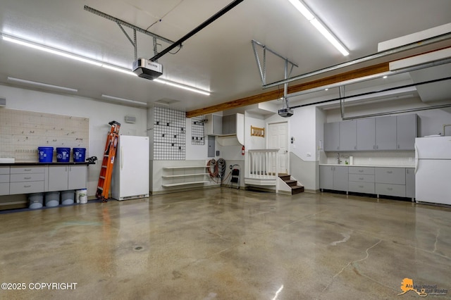 garage with freestanding refrigerator and a garage door opener
