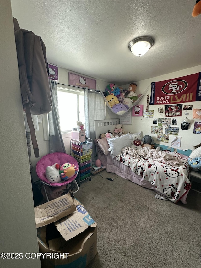 bedroom with a textured ceiling and carpet