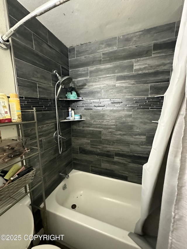 bathroom with shower / tub combo and toilet