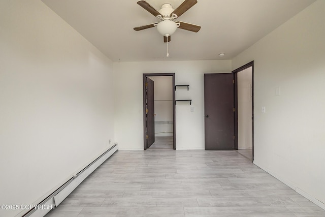 8516 Boundary Ave # E3, Anchorage, AK 99504 - spare room with baseboard heating, ceiling fan, and light wood-type flooring