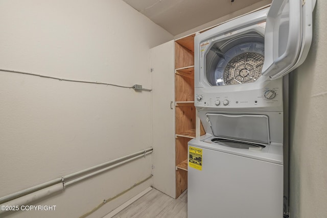8516 Boundary Ave # E3, Anchorage, AK 99504 - laundry area featuring stacked washer / dryer and light wood-style floors