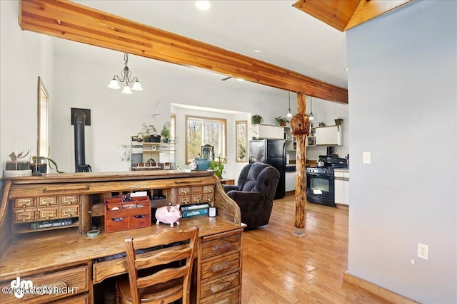 living area with light wood-style flooring, recessed lighting, a chandelier, beamed ceiling, and a wood stove