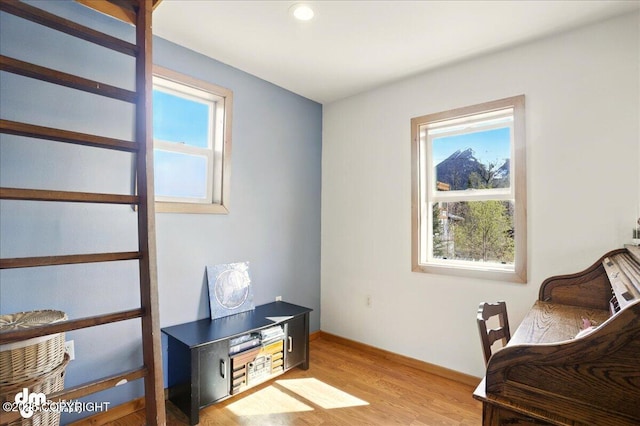 living area with light wood-type flooring, baseboards, and recessed lighting