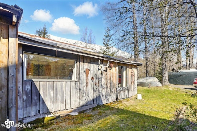 view of home's exterior with a lawn