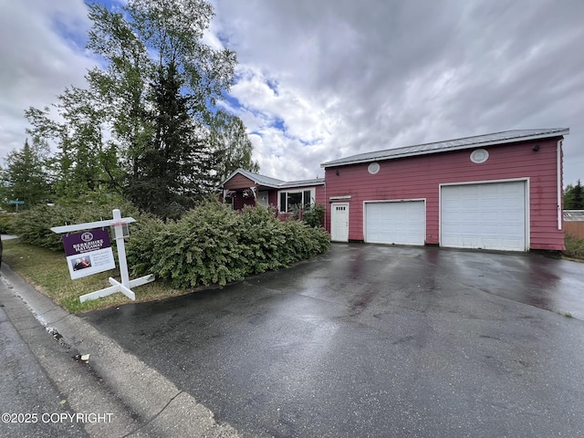 7700 Dover Ave, Anchorage, AK 99504 - view of front of property with driveway and an attached garage