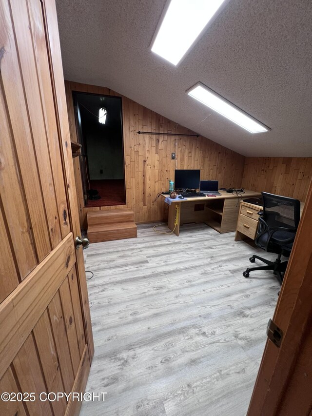 7700 Dover Ave, Anchorage, AK 99504 - office space featuring lofted ceiling, light wood-style floors, wood walls, and a textured ceiling