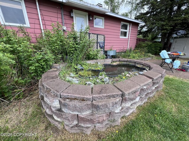 7700 Dover Ave, Anchorage, AK 99504 - view of yard with a garden pond