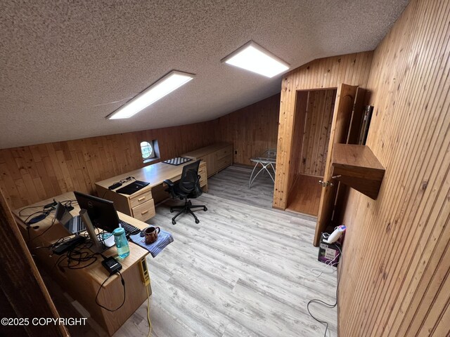 7700 Dover Ave, Anchorage, AK 99504 - home office with wooden walls, lofted ceiling, a textured ceiling, and wood finished floors