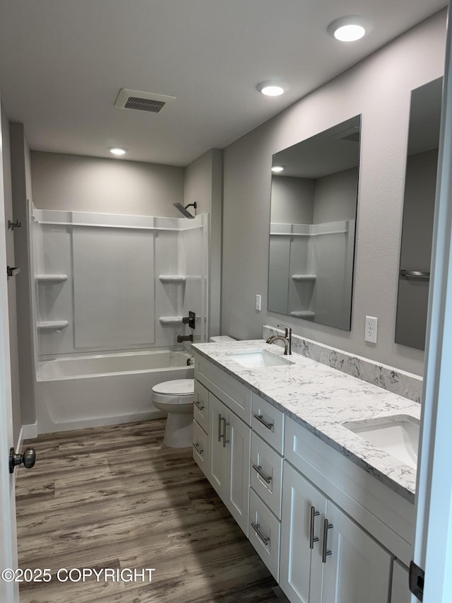 3120 W Wintergreen Dr, Wasilla, AK 99623 - full bath with double vanity, shower / washtub combination, and wood finished floors