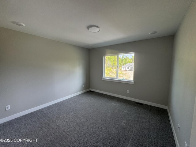 3120 W Wintergreen Dr, Wasilla, AK 99623 - unfurnished room featuring baseboards and dark carpet