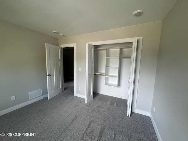 3120 W Wintergreen Dr, Wasilla, AK 99623 - unfurnished bedroom with dark carpet and a closet