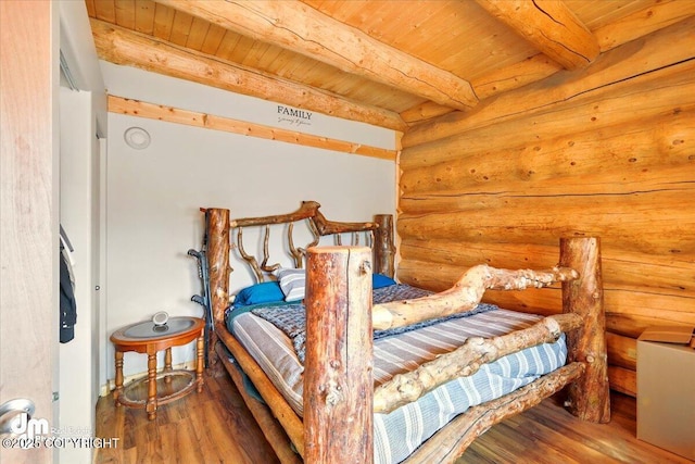 bedroom featuring rustic walls, wood finished floors, beam ceiling, and wood ceiling