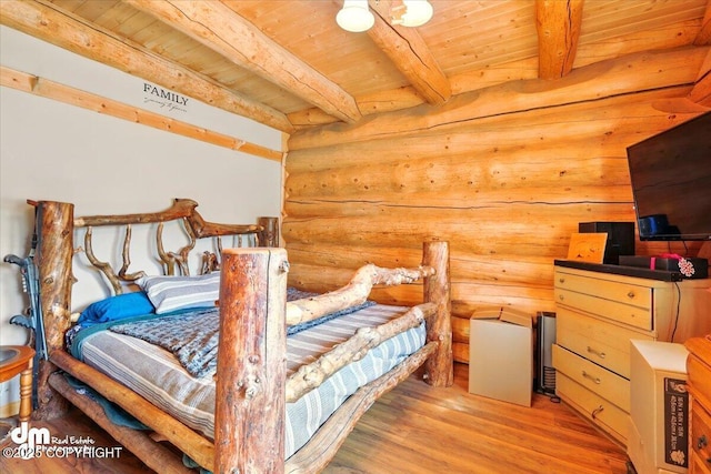 bedroom featuring log walls, wooden ceiling, light wood finished floors, and beam ceiling