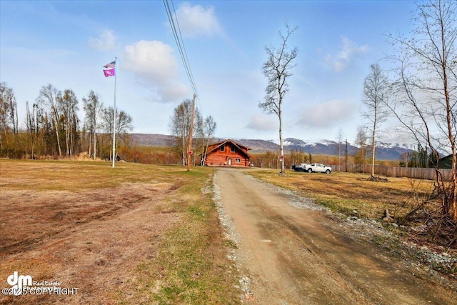 view of dirt / gravel driveway with a mountain view