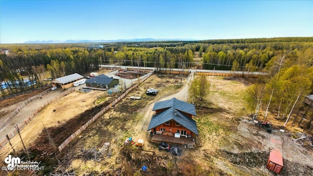 aerial view of property and surrounding area with a forest