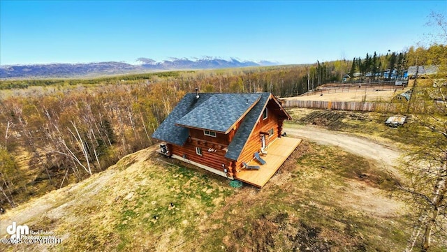 aerial view of property and surrounding area with a heavily wooded area