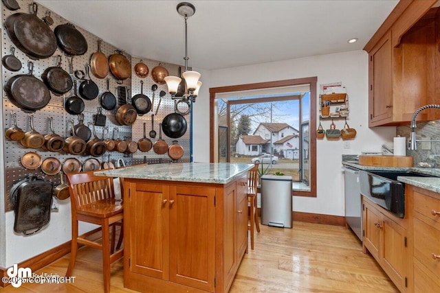 10613 Washington Cir, Anchorage, AK 99515 - kitchen with baseboards, a sink, light wood-type flooring, and stainless steel dishwasher