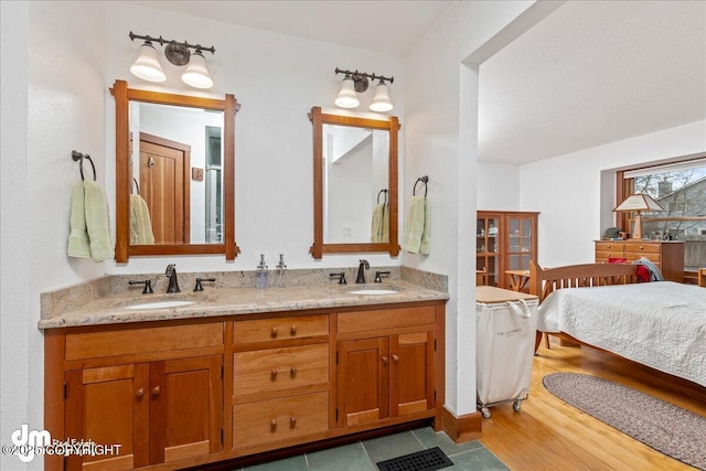 10613 Washington Cir, Anchorage, AK 99515 - bathroom featuring wood finished floors and double vanity