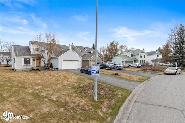 10613 Washington Cir, Anchorage, AK 99515 - view of front of home with a residential view, a front lawn, driveway, and a garage