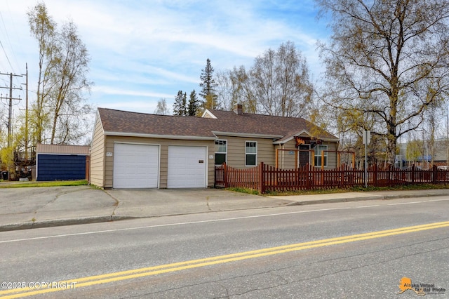 1008 Cordova St, Anchorage, AK 99501 - ranch-style house featuring a fenced front yard, driveway, a chimney, and an attached garage